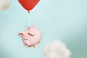 piggy bank attached to balloon